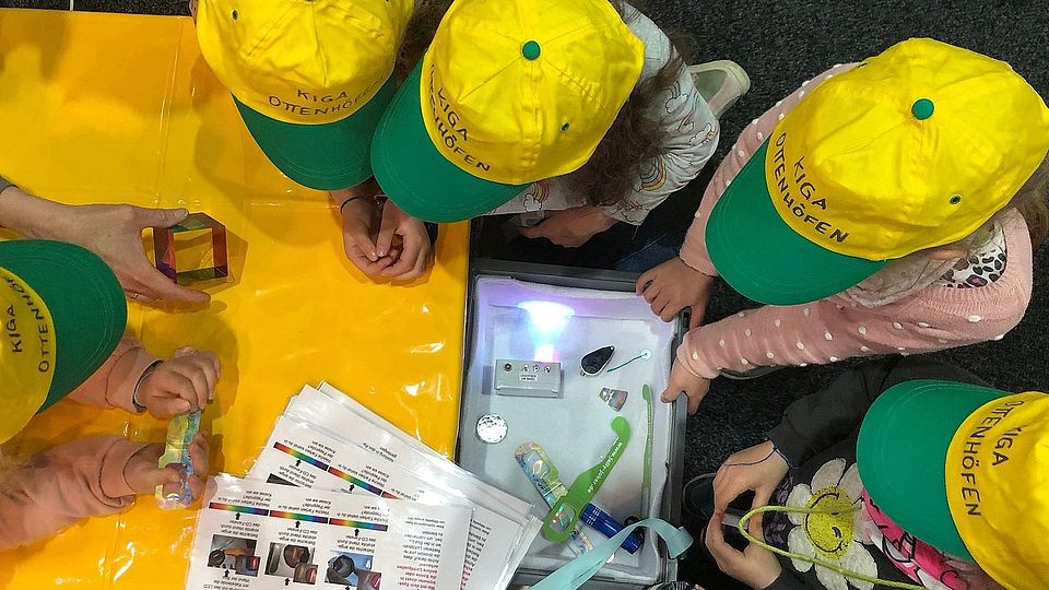 The kids are fascinated by the experiments.