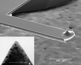 Microfabricated cantilever Scanning electron microscopy image of a microfabricated cantilever optical near-field probe with a cone-shaped quartz tip. Inset: TEM image of an Al-coated quartz tip prior to SNOM measurements